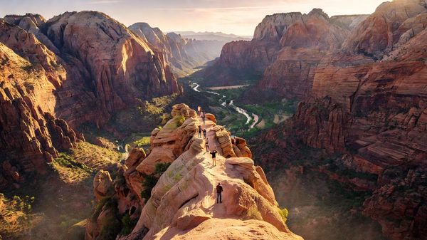 Zion Canyon's sheer sandstone walls rising above the Virgin River, seen from the canyon floor